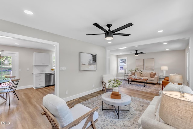 living room with recessed lighting, ceiling fan, and light wood-type flooring