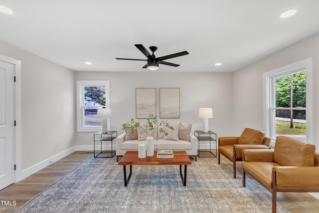 living room featuring light wood-style floors, recessed lighting, and baseboards