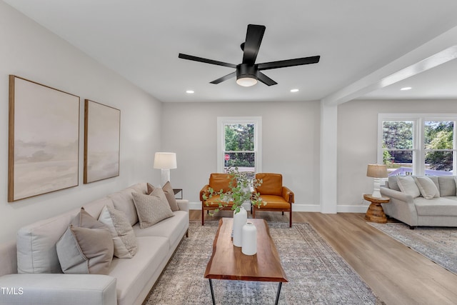 living area with baseboards, a ceiling fan, recessed lighting, and wood finished floors