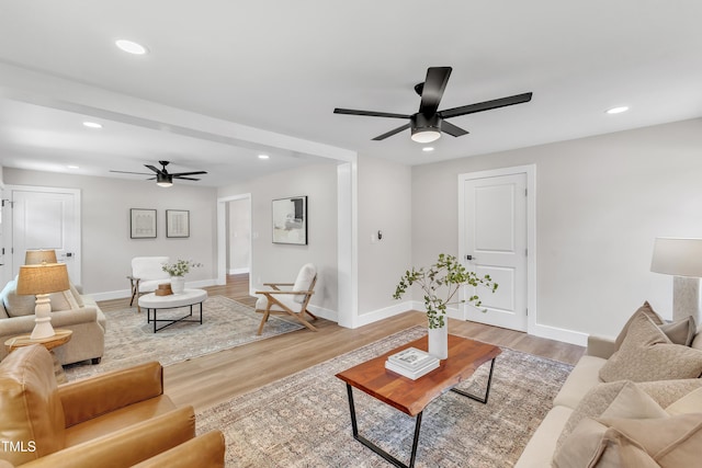 living area with a ceiling fan, baseboards, and recessed lighting