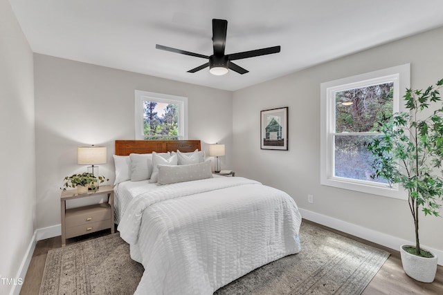 bedroom with baseboards, a ceiling fan, and wood finished floors
