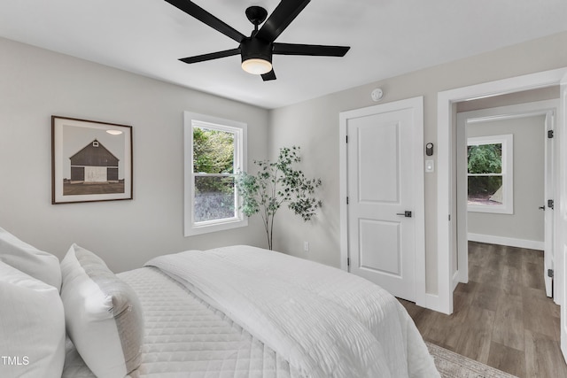 bedroom featuring baseboards, a ceiling fan, and wood finished floors