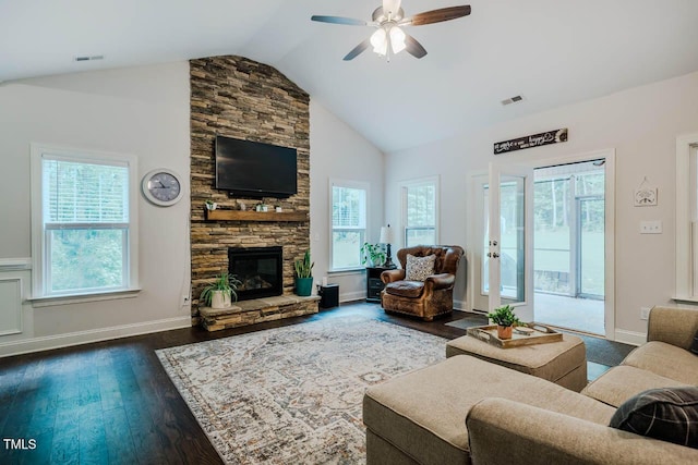 4072 Mackenzie Dr, Haw River, NC 27258 - living room with lofted ceiling, dark wood-style floors, a ceiling fan, a stone fireplace, and baseboards