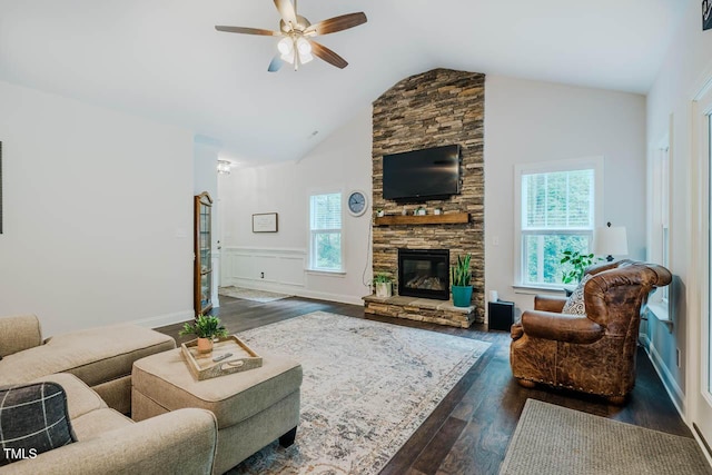 4072 Mackenzie Dr, Haw River, NC 27258 - living area with dark wood-type flooring, ceiling fan, lofted ceiling, a stone fireplace, and wainscoting