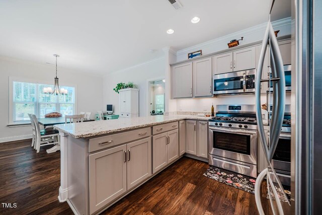 4072 Mackenzie Dr, Haw River, NC 27258 - kitchen with stainless steel appliances, a peninsula, ornamental molding, dark wood-type flooring, and a chandelier