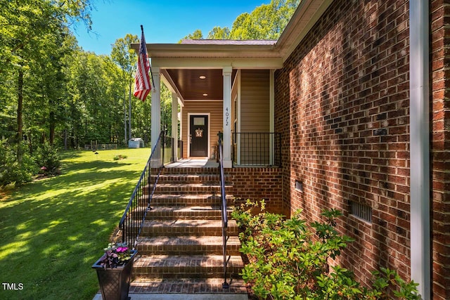 4072 Mackenzie Dr, Haw River, NC 27258 - property entrance with brick siding, a yard, and covered porch