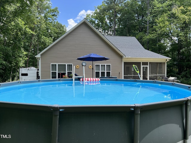 4072 Mackenzie Dr, Haw River, NC 27258 - outdoor pool featuring a sunroom and view of scattered trees
