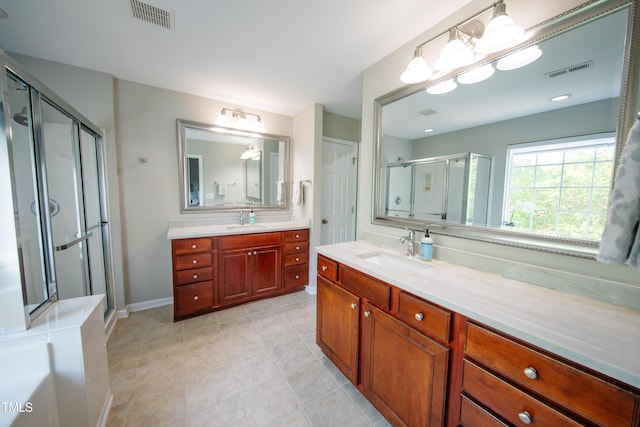 full bath with visible vents, a sink, and a stall shower
