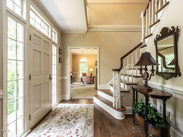 entrance foyer featuring stairway, baseboards, ornamental molding, and hardwood / wood-style flooring