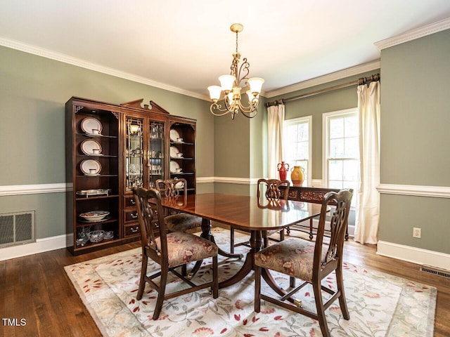 dining room with wood finished floors, a chandelier, and visible vents
