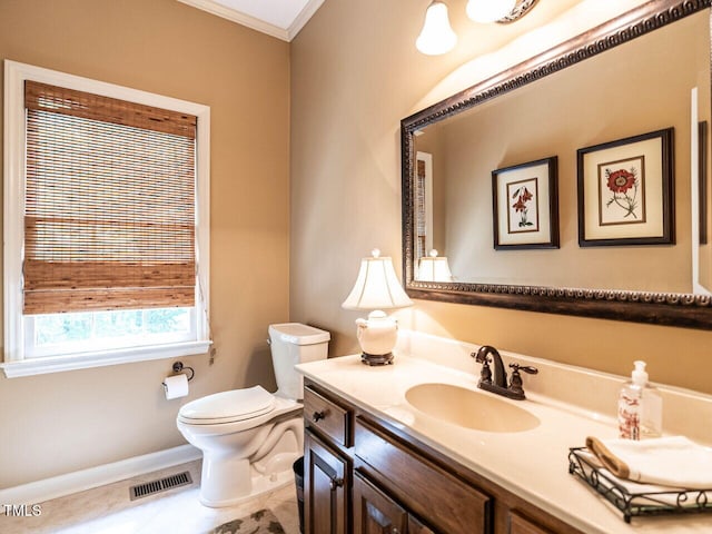 bathroom featuring visible vents, vanity, baseboards, toilet, and ornamental molding