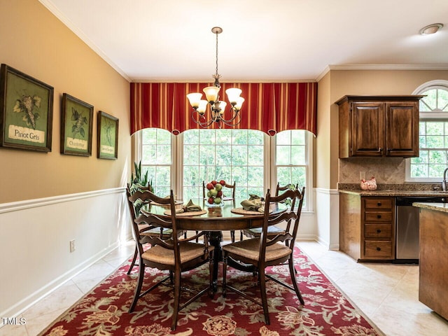 dining room featuring wainscoting, an inviting chandelier, and ornamental molding