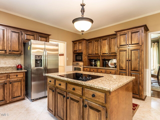 kitchen featuring ornamental molding, a kitchen island, light stone countertops, tasteful backsplash, and black appliances