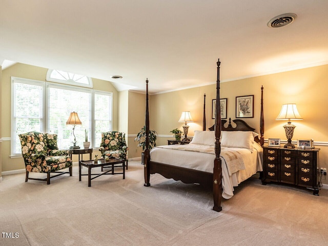 bedroom with visible vents, baseboards, lofted ceiling, ornamental molding, and light carpet