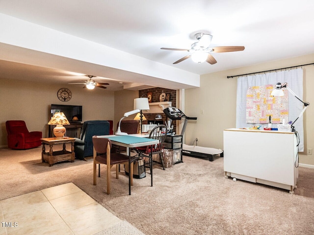 game room with carpet flooring, ceiling fan, and a fireplace