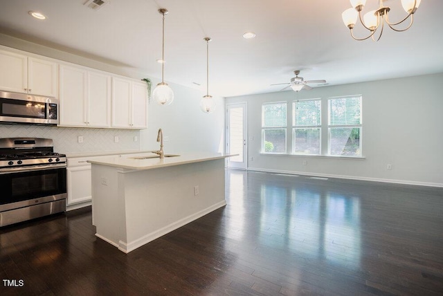 kitchen featuring decorative backsplash, baseboards, dark wood-style floors, a sink, and stainless steel appliances