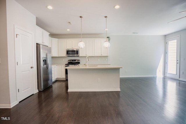 kitchen featuring light countertops, backsplash, stainless steel appliances, and dark wood-style floors