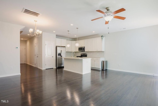 unfurnished living room featuring visible vents, dark wood-style flooring, baseboards, a sink, and ceiling fan with notable chandelier