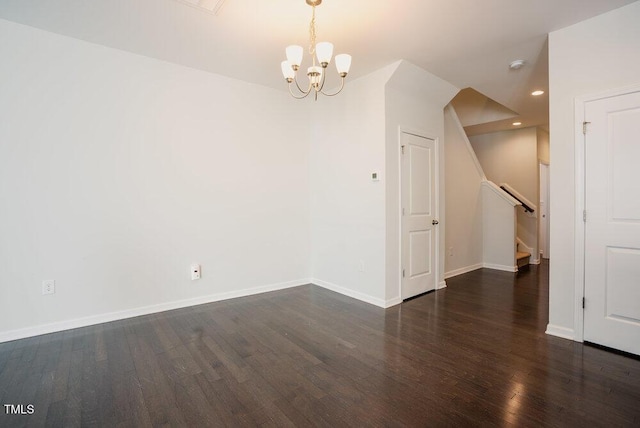 unfurnished room featuring a notable chandelier, stairs, recessed lighting, baseboards, and wood finished floors