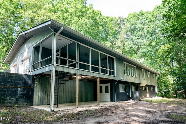 5213 Tomahawk Trl, Raleigh, NC 27610 - rear view of property with central AC and a sunroom