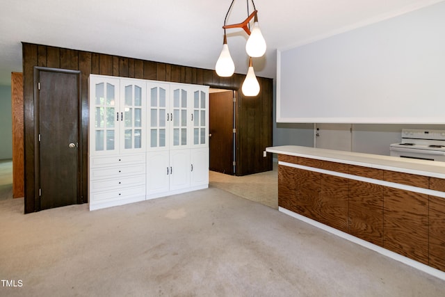 5213 Tomahawk Trl, Raleigh, NC 27610 - kitchen with white electric range, carpet flooring, wooden walls, and decorative light fixtures
