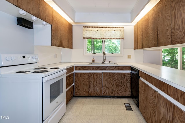 5213 Tomahawk Trl, Raleigh, NC 27610 - kitchen with white electric range oven, a sink, dishwasher, and light countertops