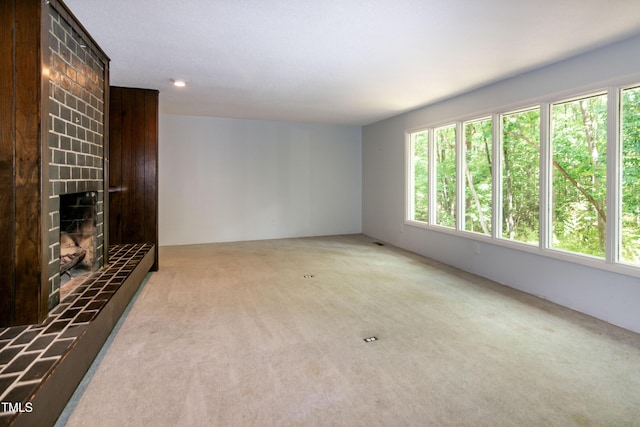 5213 Tomahawk Trl, Raleigh, NC 27610 - unfurnished living room featuring carpet floors, plenty of natural light, and a tile fireplace