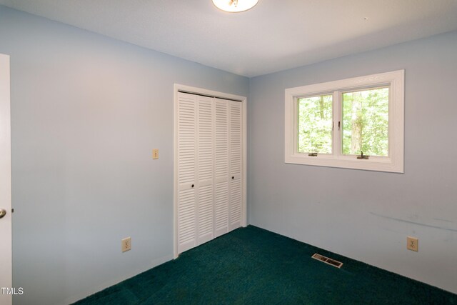 5213 Tomahawk Trl, Raleigh, NC 27610 - unfurnished bedroom with dark colored carpet and a closet
