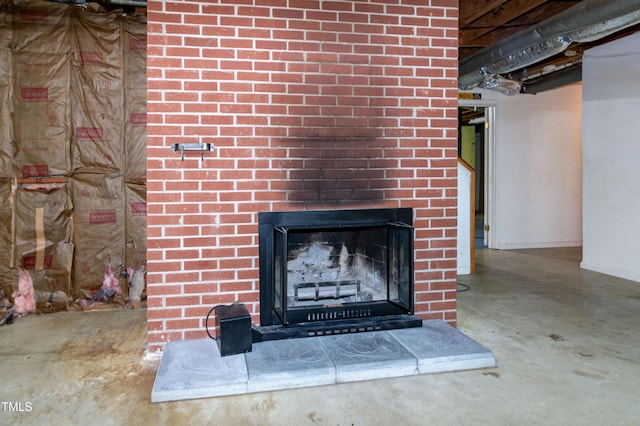 5213 Tomahawk Trl, Raleigh, NC 27610 - basement view of concrete flooring, a fireplace, and baseboards