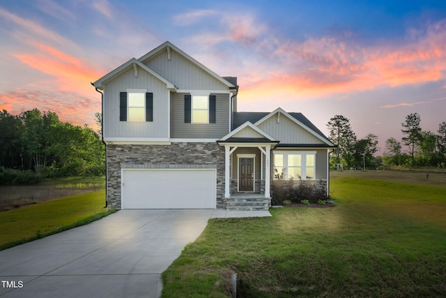 view of front of property with concrete driveway, an attached garage, stone siding, and a front yard