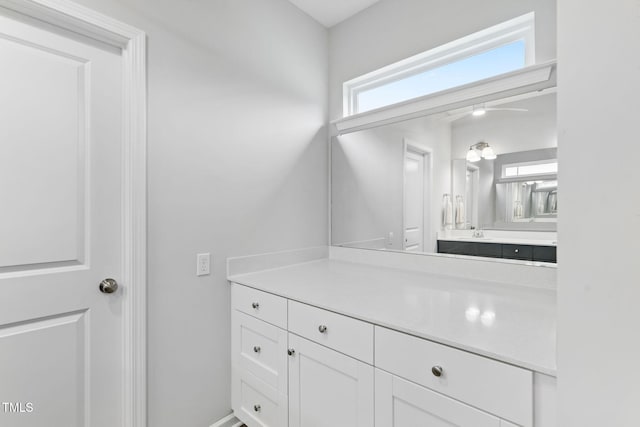 bathroom with a ceiling fan and vanity