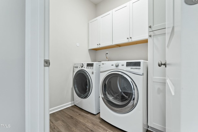 laundry room featuring cabinet space, dark wood finished floors, and washer and dryer