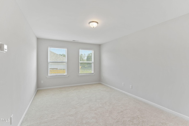 carpeted spare room with baseboards