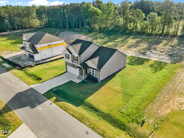 birds eye view of property with a view of trees