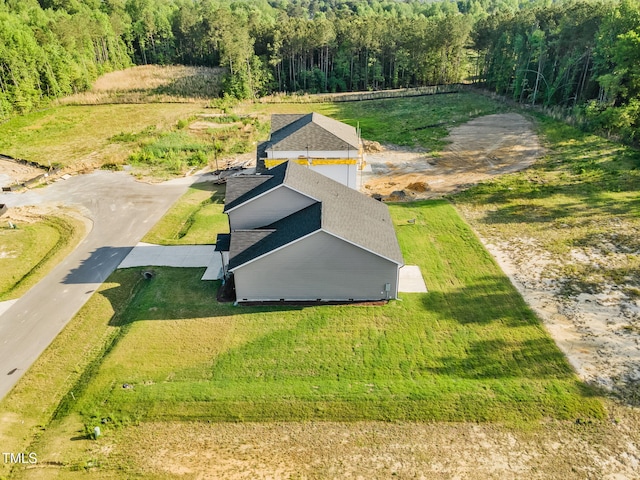 drone / aerial view featuring a forest view