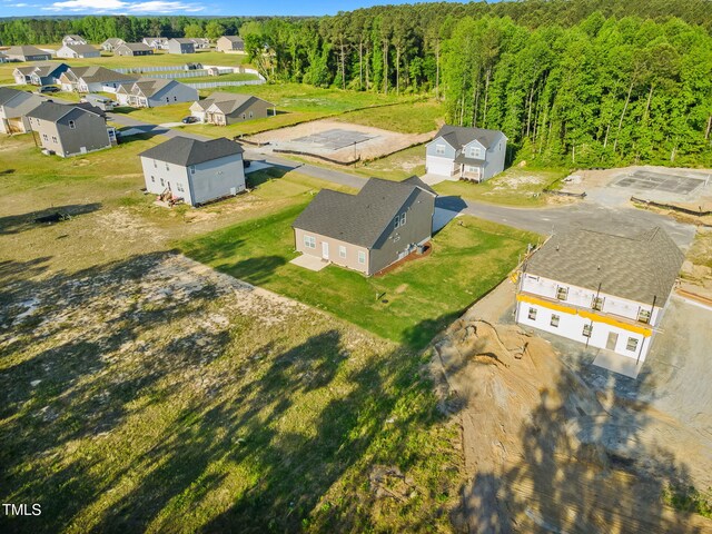 drone / aerial view featuring a forest view and a residential view