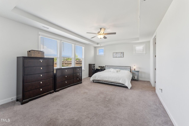 104 Lingonberry Dr, Holly Springs, NC 27540 - bedroom featuring visible vents, carpet floors, baseboards, a tray ceiling, and a ceiling fan