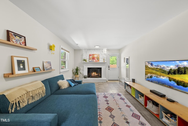 living room with tile patterned flooring and a fireplace