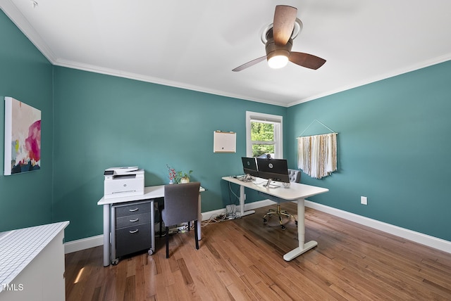 home office with baseboards, ornamental molding, a ceiling fan, and wood finished floors