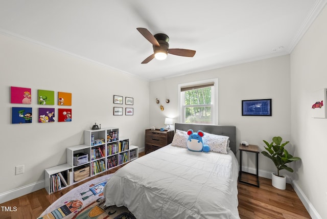 bedroom featuring ceiling fan, baseboards, ornamental molding, and wood finished floors