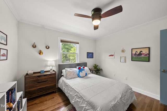 bedroom with a ceiling fan, baseboards, ornamental molding, and wood finished floors