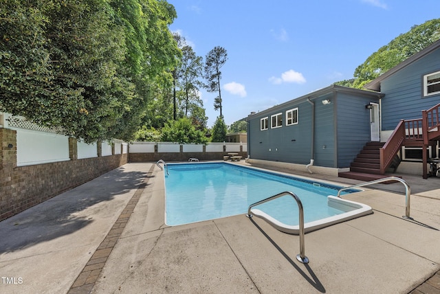 view of swimming pool with a fenced backyard, a fenced in pool, and a patio area