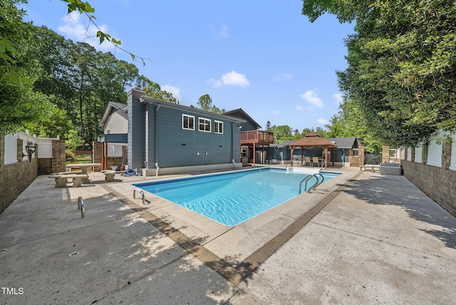 view of swimming pool featuring a fenced in pool, an outbuilding, a gazebo, and a patio area
