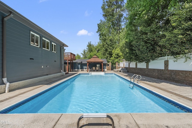 view of pool featuring a gazebo, a fenced backyard, a fenced in pool, and a patio