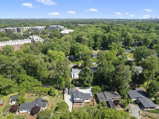 bird's eye view featuring a wooded view
