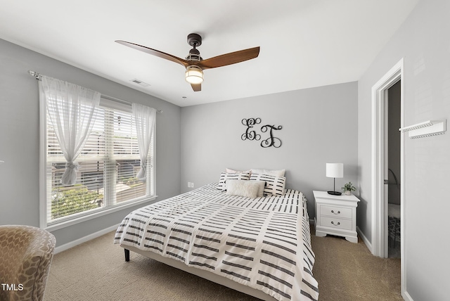 carpeted bedroom with visible vents, a ceiling fan, and baseboards