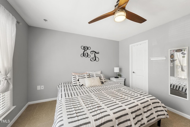carpeted bedroom featuring a ceiling fan and baseboards