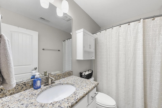 bathroom featuring vanity, toilet, and visible vents