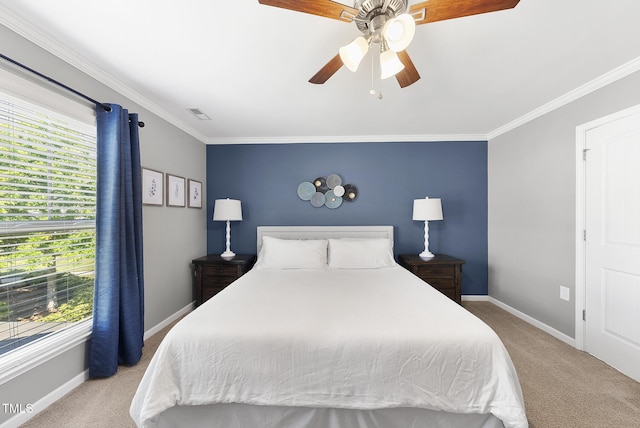 carpeted bedroom featuring baseboards, visible vents, ornamental molding, and ceiling fan