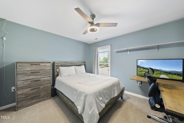 carpeted bedroom with baseboards and ceiling fan